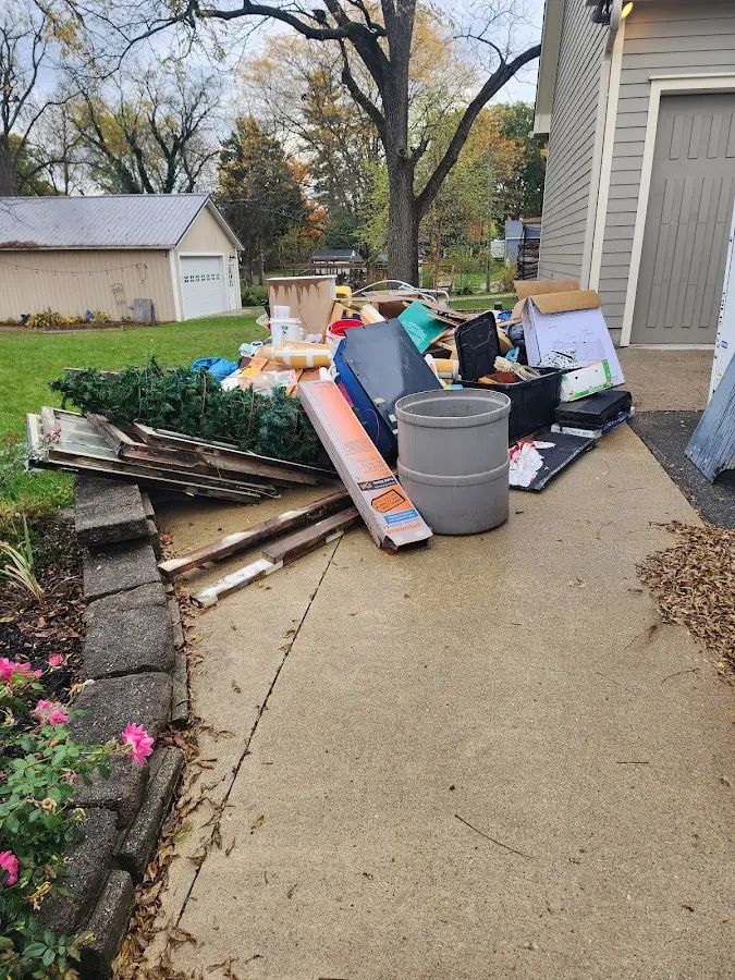 Dumpster being loaded with debris for Estate Cleanout Dumpster Rental in Scotia